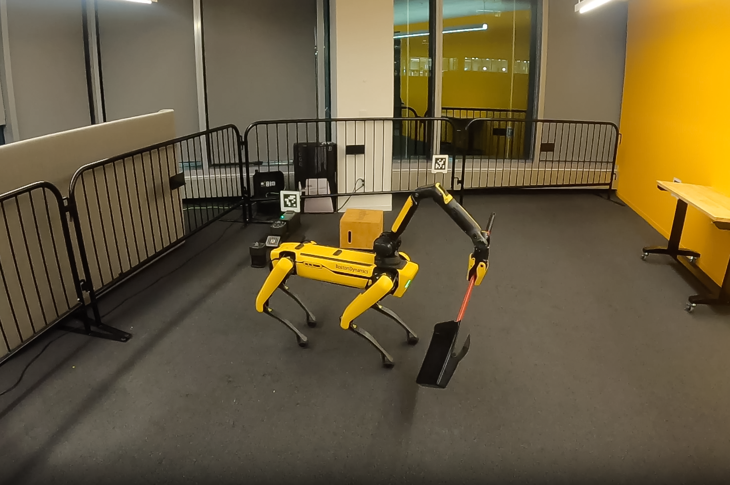 quadruped robot holding a dustpan